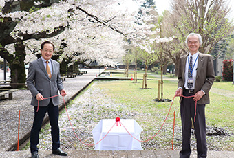 銘板の除幕式での益学長（左）、佐藤理事・副学長（右）