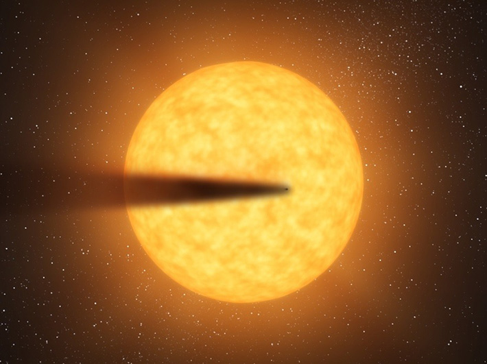 図1. 恒星の前を通過する解体惑星と「塵の尾」のイメージ図